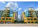 Beautiful building exterior featuring modern architecture, blue skies and palm trees at 1208 E Kennedy Blvd # 1115, Tampa, FL 33602