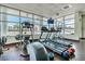 Well-lit gym featuring treadmills, a rowing machine, and medicine balls, ideal for a complete workout at 1208 E Kennedy Blvd # 1115, Tampa, FL 33602