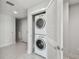 Stacked washer and dryer concealed behind a louvered closet door in laundry area at 1208 E Kennedy Blvd # 1115, Tampa, FL 33602