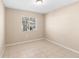 Cozy bedroom featuring neutral walls, tile flooring, and natural light from a window at 12112 Feldwood Creek Ln, Riverview, FL 33579