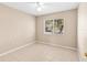 Bedroom featuring tile floors, neutral wall paint, and natural light from a window at 12112 Feldwood Creek Ln, Riverview, FL 33579