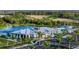 Aerial view of community center, lake, pool, and lush landscaping at 12419 Hearts Ease St, Venice, FL 34293