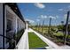 Scenic walking path lined with lush landscaping and charming string lights for evening strolls at 12419 Hearts Ease St, Venice, FL 34293