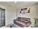 This bedroom features a comfy leather sofa, a blue ottoman, and sports-themed decor at 12818 Crested Iris Way, Riverview, FL 33579