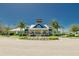 View of a welcoming community clubhouse with well-kept landscaping and a blue accent tower at 12818 Crested Iris Way, Riverview, FL 33579