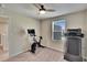 Home exercise room with a treadmill, stationary bike, and ceiling fan at 12818 Crested Iris Way, Riverview, FL 33579