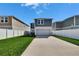 Exterior view of the home with a two-car garage, fenced yard, and a well-maintained lawn at 12818 Crested Iris Way, Riverview, FL 33579