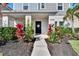 Inviting entryway with lush landscaping leading to a welcoming front door at 12818 Crested Iris Way, Riverview, FL 33579