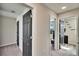 Upstairs hallway with carpeted floors and doors to the bedrooms and laundry room at 12818 Crested Iris Way, Riverview, FL 33579