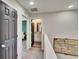 Upstairs hallway with carpeted floor and a view of the bathroom and bedroom at 12818 Crested Iris Way, Riverview, FL 33579