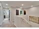 Upstairs hallway with carpeted floors and doors to the bedrooms and laundry room at 12818 Crested Iris Way, Riverview, FL 33579