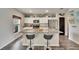 Modern kitchen with stainless steel appliances, granite countertops, a granite island and barstool seating at 12818 Crested Iris Way, Riverview, FL 33579