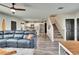 Open-concept living room and dining area features hardwood floors and plenty of natural light at 12818 Crested Iris Way, Riverview, FL 33579