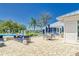 Inviting poolside patio area with comfortable seating and lush landscaping at 12818 Crested Iris Way, Riverview, FL 33579