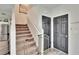 Carpeted stairs with railing lead to upper level, with a safety gate at the bottom at 12818 Crested Iris Way, Riverview, FL 33579