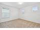 Bright bedroom featuring neutral carpeting and two bright windows at 13729 Evergreen Valley Dr, Riverview, FL 33578