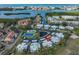 Aerial view of a waterfront condo community with pool, tennis court and boat docks at 14505 Catalina Cir, Seminole, FL 33776