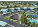 Overhead aerial shot showing the pond, tennis court, swimming pool, and townhomes at 14505 Catalina Cir, Seminole, FL 33776