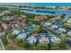 Aerial view of a waterfront condo community with pool, tennis court and boat docks at 14505 Catalina Cir, Seminole, FL 33776