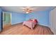 Cozy bedroom featuring wood flooring and a ceiling fan at 14505 Catalina Cir, Seminole, FL 33776