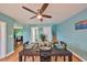 Dining room table with seating for four, ceiling fan, and brightly painted walls at 14505 Catalina Cir, Seminole, FL 33776