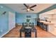 Open dining area with wood floors, table set for four, and view into the bright and open kitchen at 14505 Catalina Cir, Seminole, FL 33776