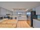 Well-lit kitchen with stainless steel appliances, neutral countertops and central wooden island at 14505 Catalina Cir, Seminole, FL 33776