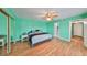 Airy main bedroom featuring wood floors, mirrored closet, and ensuite bathroom at 14505 Catalina Cir, Seminole, FL 33776