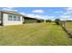 Expansive backyard features a large grassy area with greenery extending to the property line at 1545 Emerald Dunes Dr, Sun City Center, FL 33573