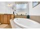 Bright bathroom with granite counters and a stylish soaking tub at 1545 Emerald Dunes Dr, Sun City Center, FL 33573