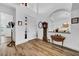 Elegant foyer with wood-look tile flooring, high ceilings, and a classic grandfather clock at 1545 Emerald Dunes Dr, Sun City Center, FL 33573