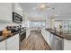 Open layout kitchen featuring stainless steel appliances, and seamless flow to dining area at 1545 Emerald Dunes Dr, Sun City Center, FL 33573