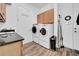 Functional laundry room features modern washer and dryer, granite counters and built-in cabinets at 1545 Emerald Dunes Dr, Sun City Center, FL 33573