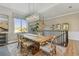 Elegant dining room with a rustic wood table, unique chandelier, and stylish decor at 18 Franklin S Ct # D, St Petersburg, FL 33711