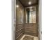 Interior of a home elevator, featuring wood-paneled walls, a decorative mirror, and plush carpet at 18 Franklin S Ct # D, St Petersburg, FL 33711