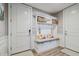 Mudroom area in the entryway features built-in bench seating, storage, and decorative seashell accents at 18 Franklin S Ct # D, St Petersburg, FL 33711