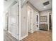 Hallway featuring wood floors, neutral wall paint, and decorative artwork at 18 Franklin S Ct # D, St Petersburg, FL 33711