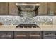 Close up of the kitchen backsplash, vent hood, and stovetop at 18 Franklin S Ct # D, St Petersburg, FL 33711