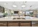 Open kitchen featuring an island with a sink overlooking the living area, and modern pendant lighting at 18 Franklin S Ct # D, St Petersburg, FL 33711