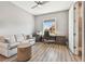 Neutral home office with a work area by the window, a comfortable couch, and a doorway to a modern bathroom at 18 Franklin S Ct # D, St Petersburg, FL 33711