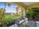 Comfortable outdoor patio with seating overlooking lush landscaping and a serene lake view at 18 Franklin S Ct # D, St Petersburg, FL 33711