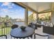 Spacious patio with dining and seating areas offering serene lake views and tropical landscaping at 18 Franklin S Ct # D, St Petersburg, FL 33711