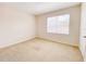 Neutral bedroom with carpet, a large window, and a door at 18001 Richmond Place Dr # 222, Tampa, FL 33647