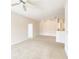 Bright, open living room with neutral carpet, paint, lighting, and view to the kitchen at 18001 Richmond Place Dr # 222, Tampa, FL 33647