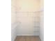 Empty walk-in closet with metal shelving provides plenty of storage space at 18001 Richmond Place Dr # 222, Tampa, FL 33647