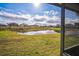 View from back porch shows pond and neighboring houses on a sunny day at 2340 Lawrence Hall St, Ruskin, FL 33570