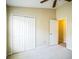 Bedroom features neutral carpet and color palette, a large closet, and an entry door at 2340 Lawrence Hall St, Ruskin, FL 33570