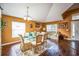 Elegant dining room with wood floors, a glass table set for six, and tasteful decor at 2340 Lawrence Hall St, Ruskin, FL 33570