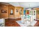 Open dining area featuring wood floors, a glass table, and a charming built-in display cabinet at 2340 Lawrence Hall St, Ruskin, FL 33570