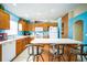 Functional kitchen featuring a breakfast bar, white appliances, and ample cabinet space at 2340 Lawrence Hall St, Ruskin, FL 33570